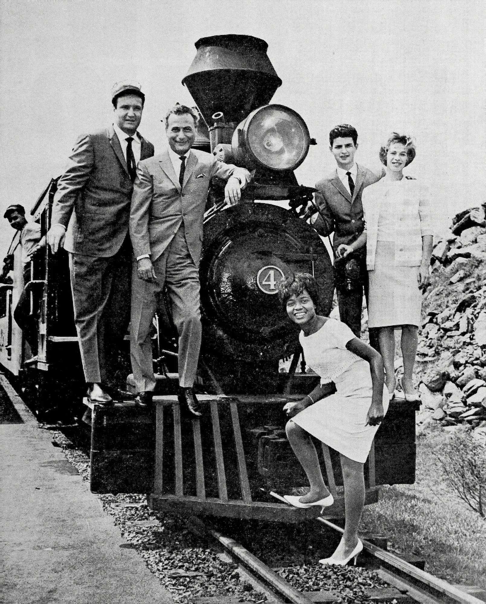 Cash Box magazine cover from 1962 showing Don Kirshner, Al Nevins, Little Eva, Gerry Goffin, and Carole King posed around a miniature locomotive.