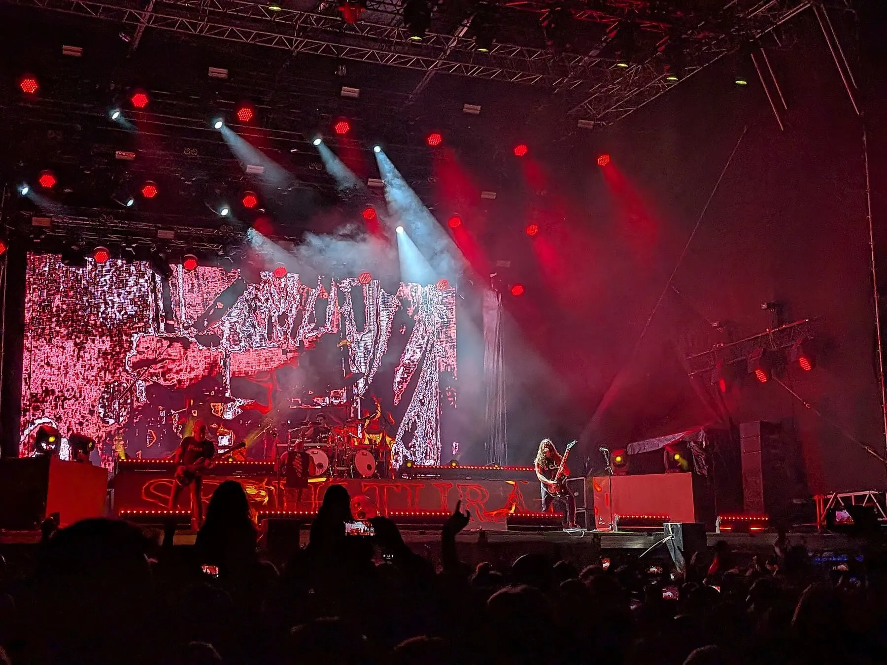 Sepultura performing as a full band under red stage lighting at Rockstadt Extreme Fest in 2025.